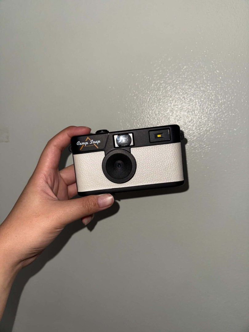 Camp Snap Camera 103B (Category: Cameras) located in Mandaluyong City. Submitted by helloakiii (Listing ID 1465900315, Image 2). Description: Camp Snap digital camera with a white textured body and black accents. Vintage point-and-shoot look without the screen. Fun device for trips, hikes, and everyday street photography. Lightweight build, easy to slip into your pocket. Price is slightly negotiable. Used once only during our taiwan trip. Rfs: go