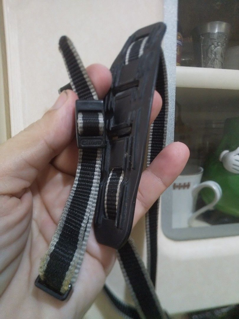 Canon Camera Strap Black Grey Adjustable (Category: Camera Bags & Carriers) located in Binan City. Submitted by rpute (Listing ID 1465847739, Image 2). Description: - 100% Original Canon camera neck strap - Stylish black and grey striped woven nylon - Textured rubber shoulder pad for all-day shooting comfort - Adjustable plastic buckles with embossed Canon logo - Standard strap ends for easy attachment to camera eyelets - Ideal as a reliable back