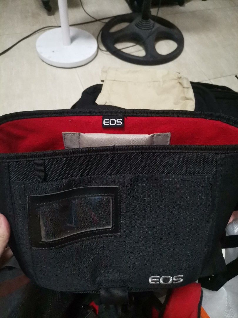Canon EOS Camera Shoulder Bag Black Red (Category: Camera Bags & Carriers) located in Makati City. Submitted by kookybearsstuff (Listing ID 1465817288, Image 1). Description: - Authentic Canon & EOS embroidered branding - Durable black nylon material with vibrant red interior lining - Secure plastic buckle closure and top grab handle - Adjustable padded divider inside for organized gear storage - Breathable mesh back padding for comfortable carry