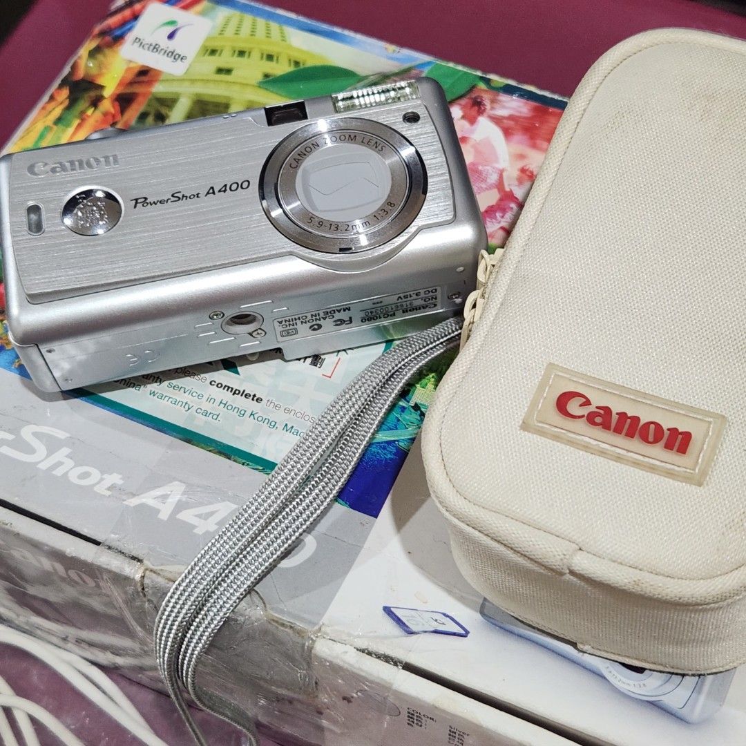 Canon PowerShot A400 Digital Camera – Like New | Complete Boxed Set (Category: Cameras) located in Bulacan. Submitted by h3nrpny (Listing ID 1465881434, Image 1). Description: Canon PowerShot A400 Digital Camera – Like New | Complete Boxed Set Good condition vintage digital camera with complete original accessories and packaging. SPECS: 3.2MP CCD Sensor 2.2× Optical Zoom 9-point AiAF Autofocus 1.5" LCD Display DIGIC Image Processor SD/MMC Memory 
