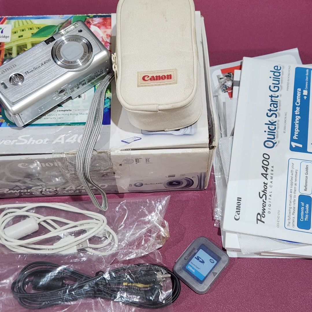 Canon PowerShot A400 Digital Camera – Like New | Complete Boxed Set (Category: Cameras) located in Bulacan. Submitted by h3nrpny (Listing ID 1465881434, Image 2). Description: Canon PowerShot A400 Digital Camera – Like New | Complete Boxed Set Good condition vintage digital camera with complete original accessories and packaging. SPECS: 3.2MP CCD Sensor 2.2× Optical Zoom 9-point AiAF Autofocus 1.5" LCD Display DIGIC Image Processor SD/MMC Memory 