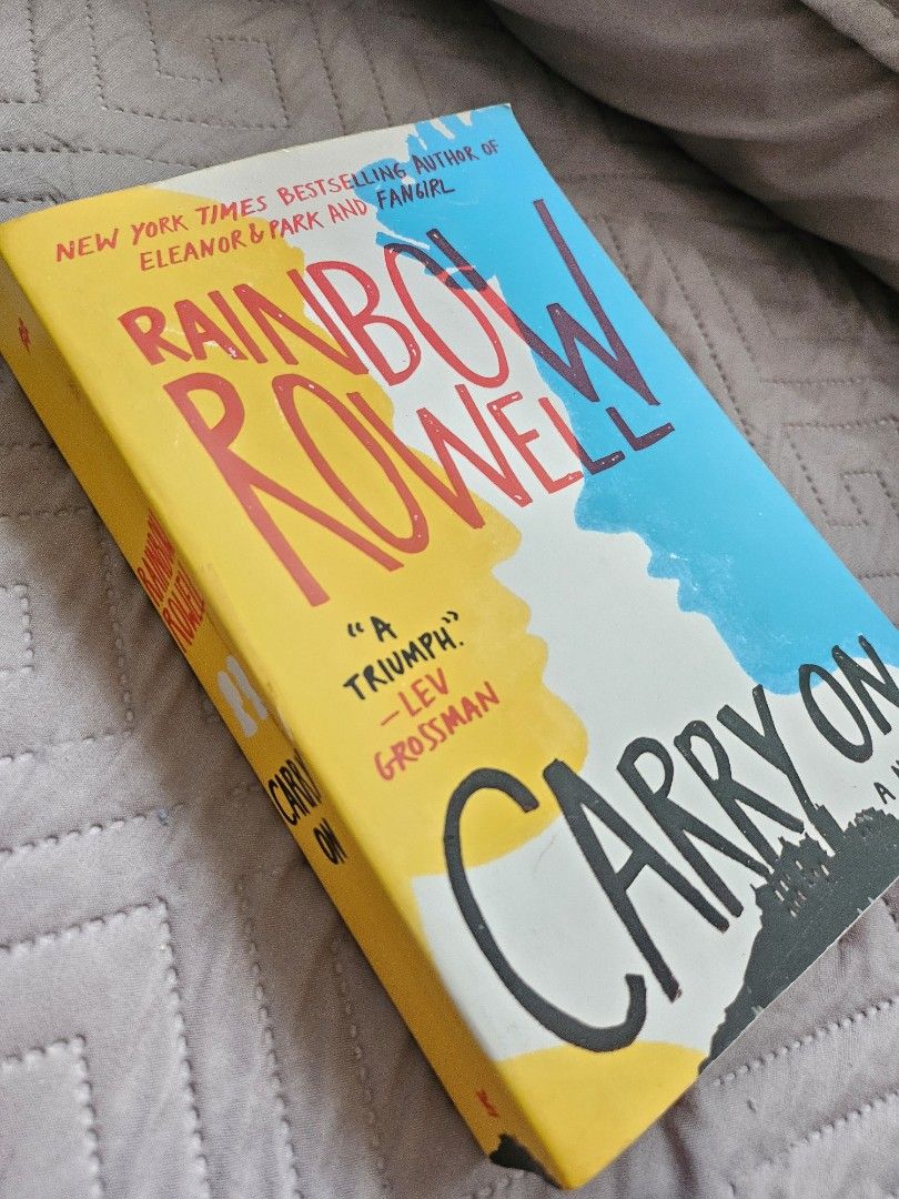 Carry On by Rainbow Rowell Paperback Novel (Category: Storybooks) located in Manila. Submitted by maggiesilang (Listing ID 1465785626, Image 1). Description: - Title: Carry On by Rainbow Rowell - Format: Paper softcover edition - Design: Colorful cover with blue, yellow, and black typography - Condition: Clean pages, ready for a new bookshelf - Genre: Perfect for fans of contemporary YA fiction and fantasy.