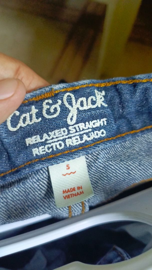 Cat & Jack Relaxed Straight Jeans Size 5 (Category: Jeans) located in Paranaque City. Submitted by cheawbeaw (Listing ID 1465807828, Image 3). Description: - Brand/Style: Cat & Jack relaxed straight denim jeans - Color: Dark blue - Size: 5 (label inside) - Origin: Made in Vietnam - Details: Single distressed rip on right knee, classic 5-pocket design, button closure, and belt loops - Condition: Good staple piece for everyday wear.