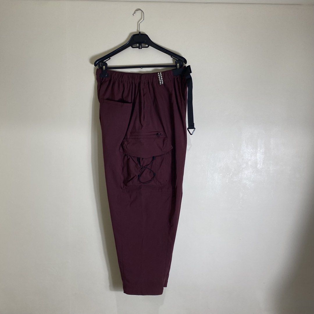Catalog Maroon Nylon Cargo Pants Size M (Category: Joggers) located in Manila. Submitted by carbertjakosalem (Listing ID 1465895023, Image 3). Description: - Brand/Model: Catalog Maroon Cargo Pants - Size: M (175/80A) - Material: 95% nylon, 5% elastane (lightweight & breathable) - Fit: Relaxed fit through the legs - Waistband: Elastic with an integrated buckle belt - Details: Multiple utility pockets and stylish bungee cord accents.