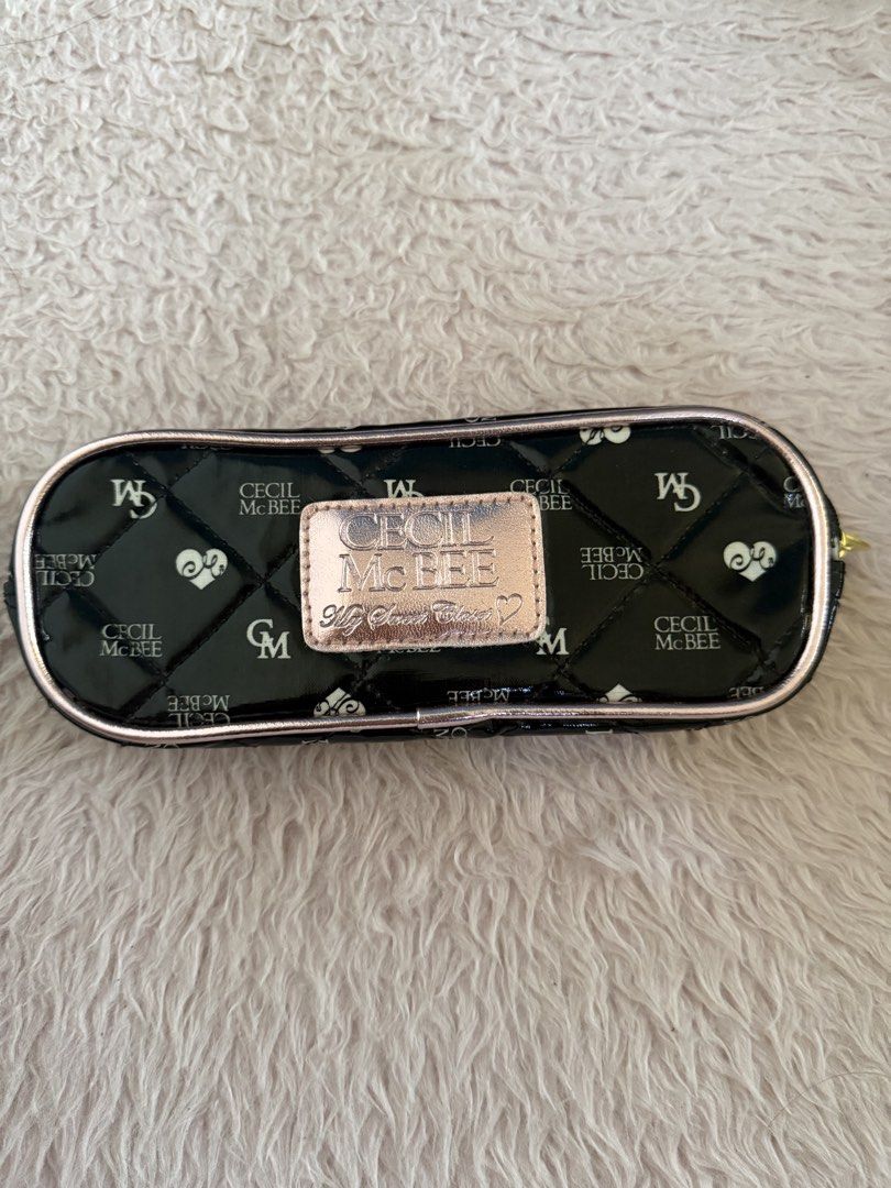 CECIL McBEE Quilted Black and Pink Pouch (Category: Purses & Pouches) located in Malolos. Submitted by gb_21895 (Listing ID 1465951715, Image 1). Description: - Brand: CECIL McBEE - Material: Black patent leather with chic diamond quilting - Design: All-over brand monogram and heart print pattern - Hardware: Rose gold metallic trim, matching logo plate with 'My Sweet Closet' text, and gold-tone zipper pull - Closure: Secure zip-around closure - I