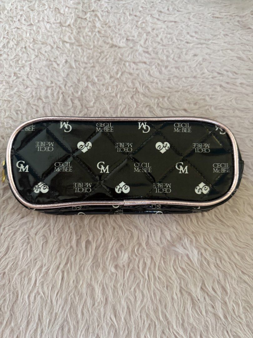 CECIL McBEE Quilted Black and Pink Pouch (Category: Purses & Pouches) located in Malolos. Submitted by gb_21895 (Listing ID 1465951715, Image 2). Description: - Brand: CECIL McBEE - Material: Black patent leather with chic diamond quilting - Design: All-over brand monogram and heart print pattern - Hardware: Rose gold metallic trim, matching logo plate with 'My Sweet Closet' text, and gold-tone zipper pull - Closure: Secure zip-around closure - I