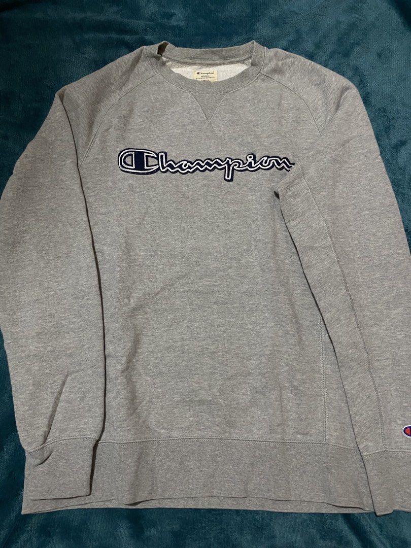 Champion Grey Script Logo Sweatshirt (Category: Coats, Jackets and Outerwear) located in Manila. Submitted by nikedropperz (Listing ID 1465926378, Image 1). Description: - Authentic grey Champion crewneck sweatshirt - Classic embroidered navy & white script logo on chest - Signature C patch logo on left sleeve cuff - Soft and cozy fleece lining for cooler weather - Ribbed collar, cuffs, and hem for a snug fit - Great for layering and casual every