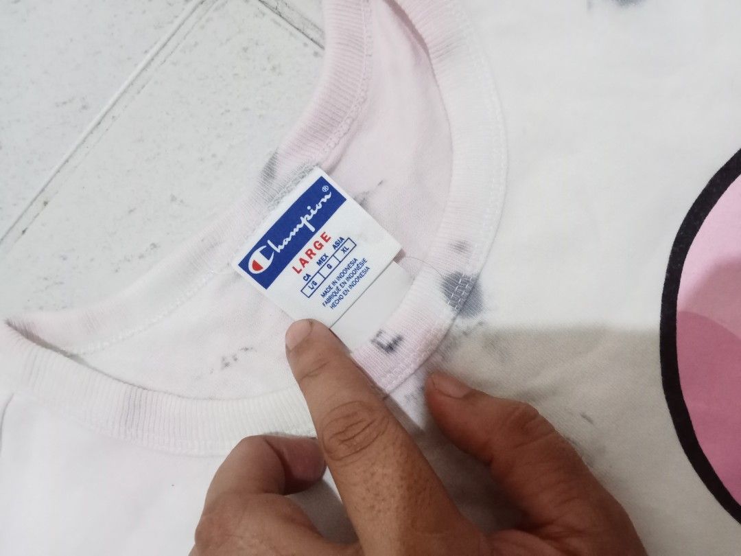 Champion Toadette Tie Dye T-Shirt (Category: Shirts) located in Manila. Submitted by kitkathrift (Listing ID 1465868290, Image 3). Description: - Brand: Champion - Character/Design: Toadette graphic with vertical script logo - Pattern/Color: Grey and white acid wash with pink accents - Size: Large - Material: 100% cotton - Origin: Made in Indonesia - Condition: Excellent, ready to wear.