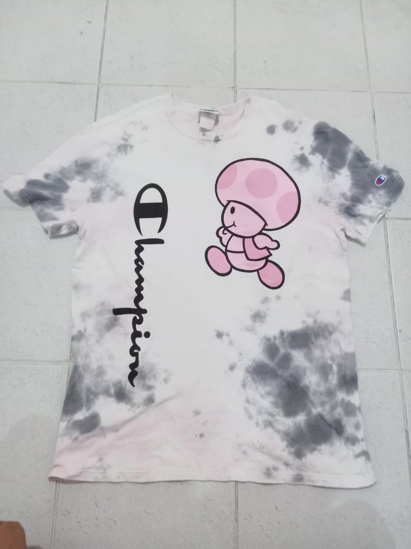 Champion Toadette Tie Dye T-Shirt (Category: Shirts) located in Manila. Submitted by kitkathrift (Listing ID 1465868290, Image 1). Description: - Brand: Champion - Character/Design: Toadette graphic with vertical script logo - Pattern/Color: Grey and white acid wash with pink accents - Size: Large - Material: 100% cotton - Origin: Made in Indonesia - Condition: Excellent, ready to wear.