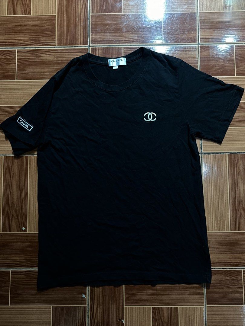 Chanel Black T-shirt with CC Logo (Category: Shirts) located in Manila. Submitted by cycy16_2004 (Listing ID 1465765518, Image 1). Description: - Brand: Chanel - Color: Black - Material: Premium cotton - Size: Small - Classic embroidered CC logo on the chest - Features branded inner collar tag and "CHANEL" box patch on the right sleeve - Includes original size tag near the neckline and bottom hem label - Condition: Brand new / Excellent (Ready to