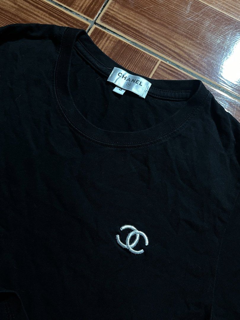 Chanel Black T-shirt with CC Logo (Category: Shirts) located in Manila. Submitted by cycy16_2004 (Listing ID 1465765518, Image 3). Description: - Brand: Chanel - Color: Black - Material: Premium cotton - Size: Small - Classic embroidered CC logo on the chest - Features branded inner collar tag and "CHANEL" box patch on the right sleeve - Includes original size tag near the neckline and bottom hem label - Condition: Brand new / Excellent (Ready to