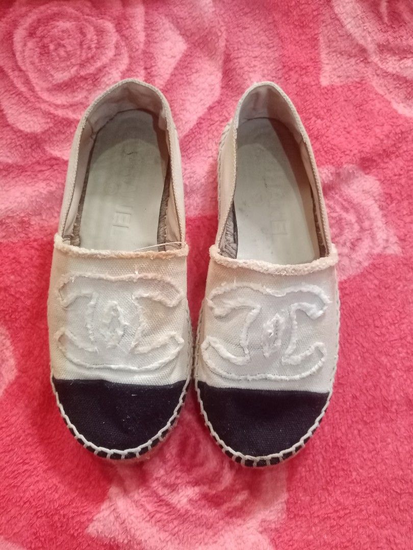 Chanel Canvas CC Espadrilles (Category: Sneakers & Footwear) located in Danao, Cebu. Submitted by althethrifter (Listing ID 1465796619, Image 1). Description: - Authentic Chanel espadrilles in white canvas with black toe caps - Features iconic large stitched CC logo on the front - Classic jute midsole trim and diamond-quilted rubber outsoles - Pre-owned condition with interior dirt and discoloration - Shows yellowish staining around the collar an