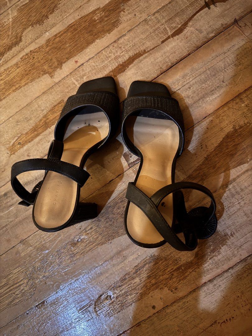 Charles & Keith Black Block Heel Sandals (Category: Heels) located in Pasig City. Submitted by klaaaaa (Listing ID 1465877659, Image 2). Description: - Brand: Charles & Keith - Color: Black - Style: Square toe with chunky woven block heel - Details: Textured front strap and ankle strap with round patterned buckle - Condition: Light signs of wear on the inside footbed - Perfect for work, casual outings, or special occasions.
