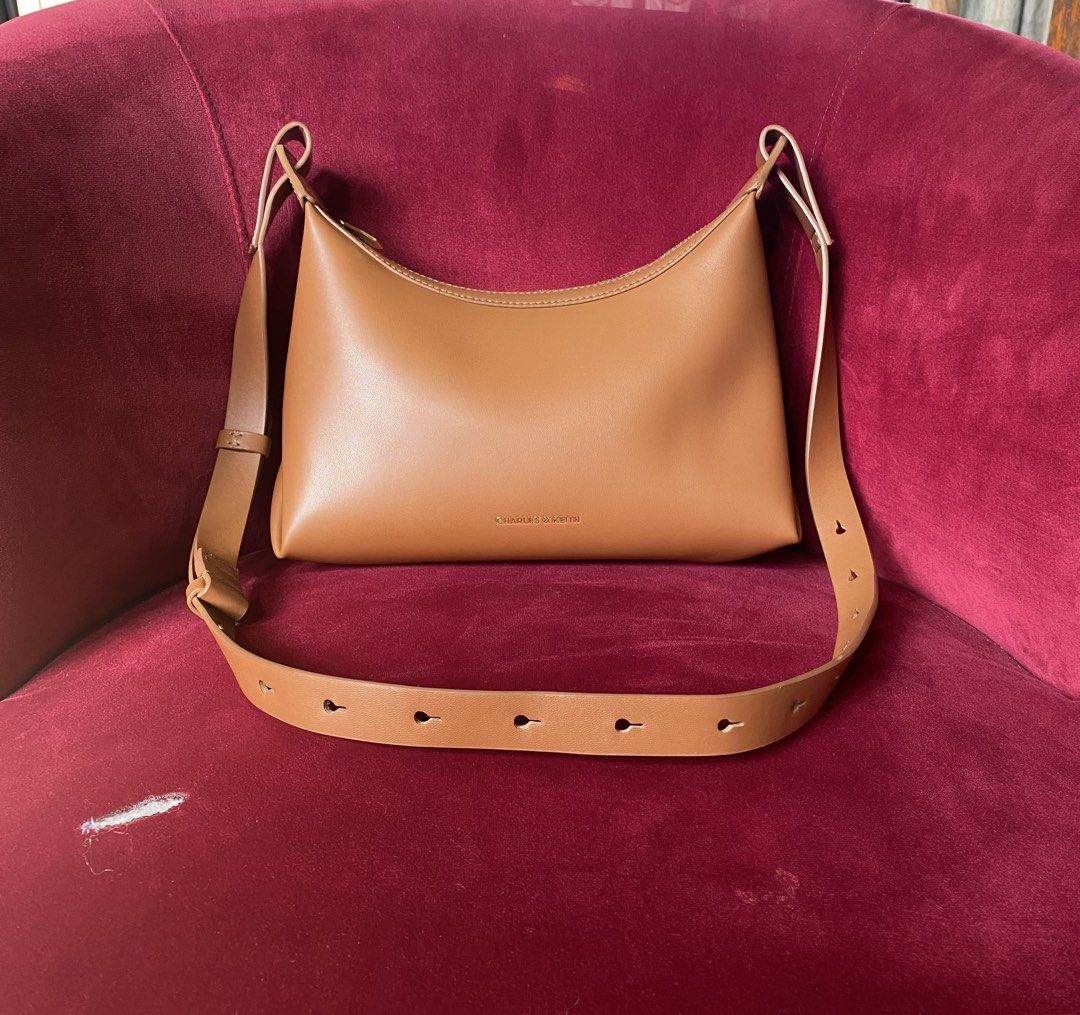 Charles & Keith Brown Shoulder Bag (Category: Shoulder Bags) located in La Trinidad. Submitted by kinleyky (Listing ID 1465766853, Image 1). Description: FREE SHIPPING ❗️❗️ - Brand: Charles & Keith - Style: Hobo shoulder bag / everyday carryall - Color: Warm caramel brown - Material: Smooth faux leather - Closure: Top zipper - Strap: Long adjustable strap with metal keyhole-style slots - Details: Gold-tone front logo stamp - Interior: Clean linin