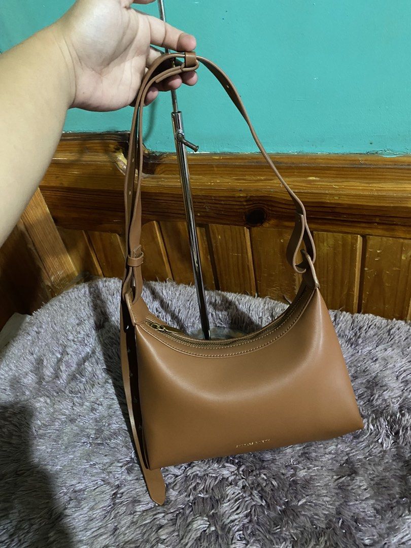 Charles & Keith Brown Shoulder Bag (Category: Shoulder Bags) located in La Trinidad. Submitted by kinleyky (Listing ID 1465766853, Image 3). Description: FREE SHIPPING ❗️❗️ - Brand: Charles & Keith - Style: Hobo shoulder bag / everyday carryall - Color: Warm caramel brown - Material: Smooth faux leather - Closure: Top zipper - Strap: Long adjustable strap with metal keyhole-style slots - Details: Gold-tone front logo stamp - Interior: Clean linin