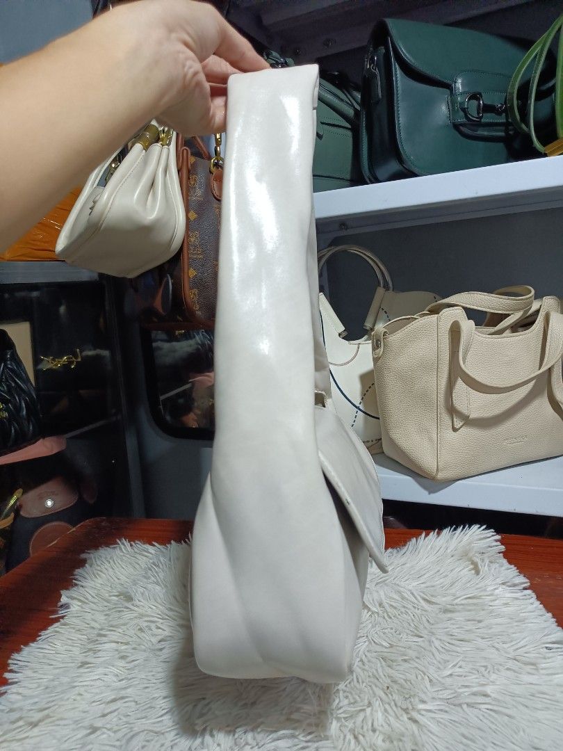 Charles & Keith White Shoulder Bag (Category: Shoulder Bags) located in Naga. Submitted by zksboutique (Listing ID 1465936045, Image 2). Description: - Brand: Charles & Keith - Color: Clean off-white (goes with everything) - Material: Soft faux leather - Closure: Front flap - Strap: Comfortable wide strap - Hardware: Silver brand lettering on the side - Size: Perfect everyday bag for phone, wallet, and keys.