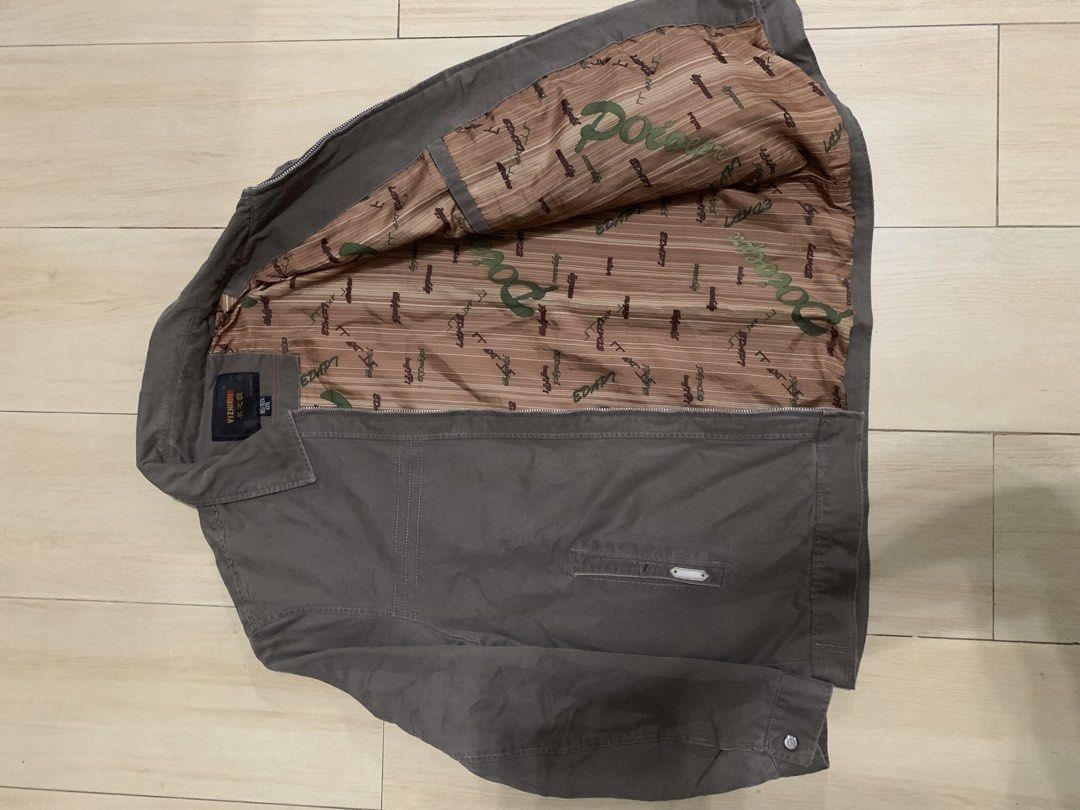 Choco Brown Harrington Jacket (Category: Coats, Jackets and Outerwear) located in Manila. Submitted by thrifty111 (Listing ID 1465924035, Image 2). Description: - Brand/Model: Yizhijun brown casual jacket - Size: XXL (Tag 185/102A) - Closure & Collar: Full zipper front with a classic lapel collar - Cuffs & Pockets: Button cuffs and dual front pockets (one with a decorative tag) - Design Details: Contrast stitching across the chest and shoulders -