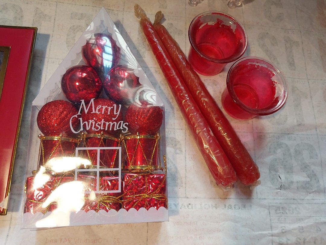 Christmas decor bundle with ornaments and picture frames (Category: Wall Decor) located in Manila. Submitted by bryantoyshop (Listing ID 1465760160, Image 3). Description: - Festive holiday decor bundle, includes everything pictured - 2x Red picture frames with Christmas art - Sparkly red and blue baubles in packaging - 1x Clear plastic reindeer figure - 2x Long red taper candles with matching red glass holders - 2x Glass tealight holders.