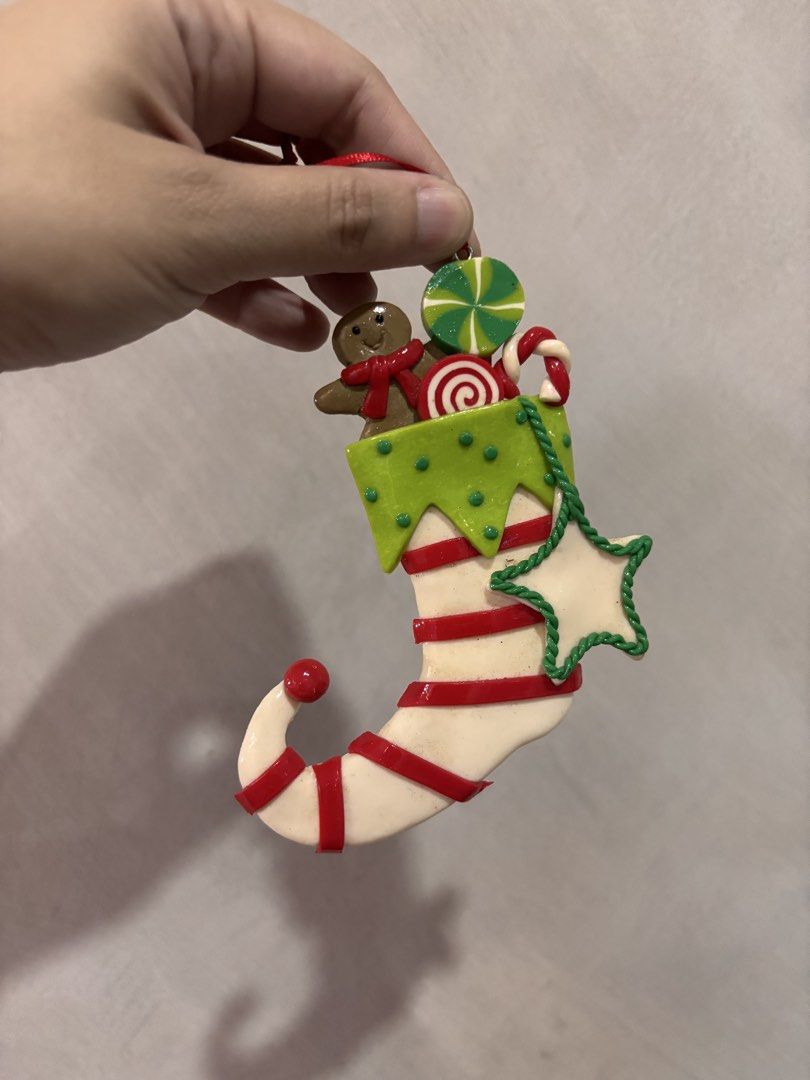 Christmas Elf Shoe Stocking Ornament Candy Gingerbread Decor (Category: Other Home Decor) located in Quezon City. Submitted by onlinebazaare (Listing ID 1465932682, Image 1). Description: - Festive Christmas elf boot ornament filled with assorted sweets - Features a cute gingerbread cookie peeking out over the top - Decorated with lollipops, candy canes, and a green-outlined hanging star - Designed as a white stocking with classic red stripes and
