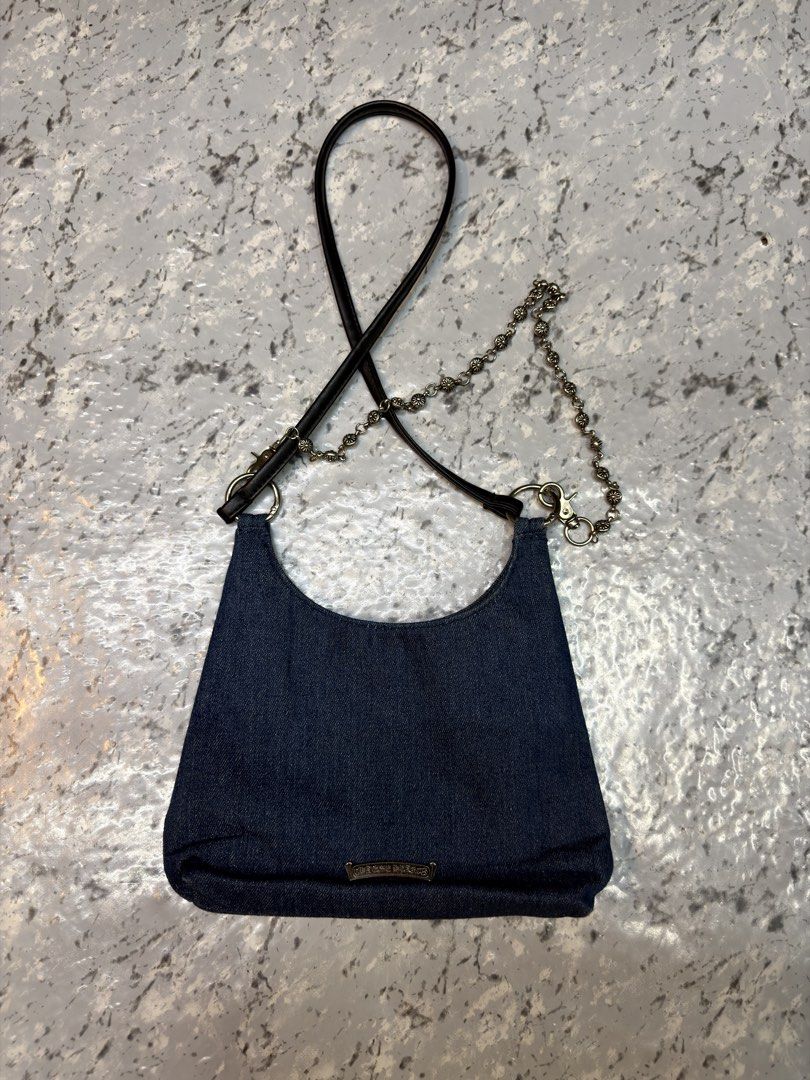 Chrome Hearts Denim Dagger Shoulder Bag (Category: Shoulder Bags) located in Manila. Submitted by raven236 (Listing ID 1465791539, Image 2). Description: - Dark denim shoulder bag with edgy silver hardware - Features a distinct front silver dagger charm - Metal engraved logo plaque at the back base - Stylish strap combining leather and metal chain links - Secure top zip closure along the curve.