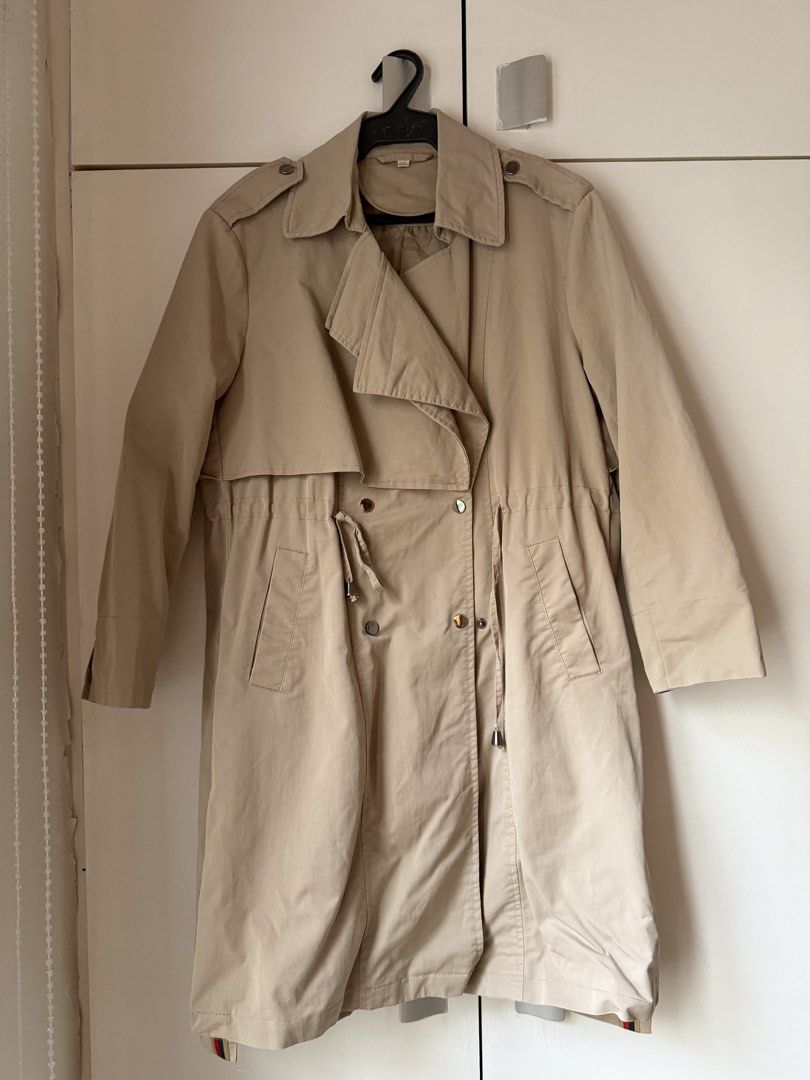 Classic Beige Trench Coat (Category: Coats, Jackets and Outerwear) located in Cainta. Submitted by jerichoesguerra (Listing ID 1465921181, Image 1). Description: - Color: Classic Beige - Design: Double-breasted buttons, wide lapels, and shoulder epaulets - Fit: Adjustable waist drawstring for a flattering silhouette - Features: Two front slant pockets and long sleeves with cuff details - Material: Lightweight fabric, ideal for layering during chi