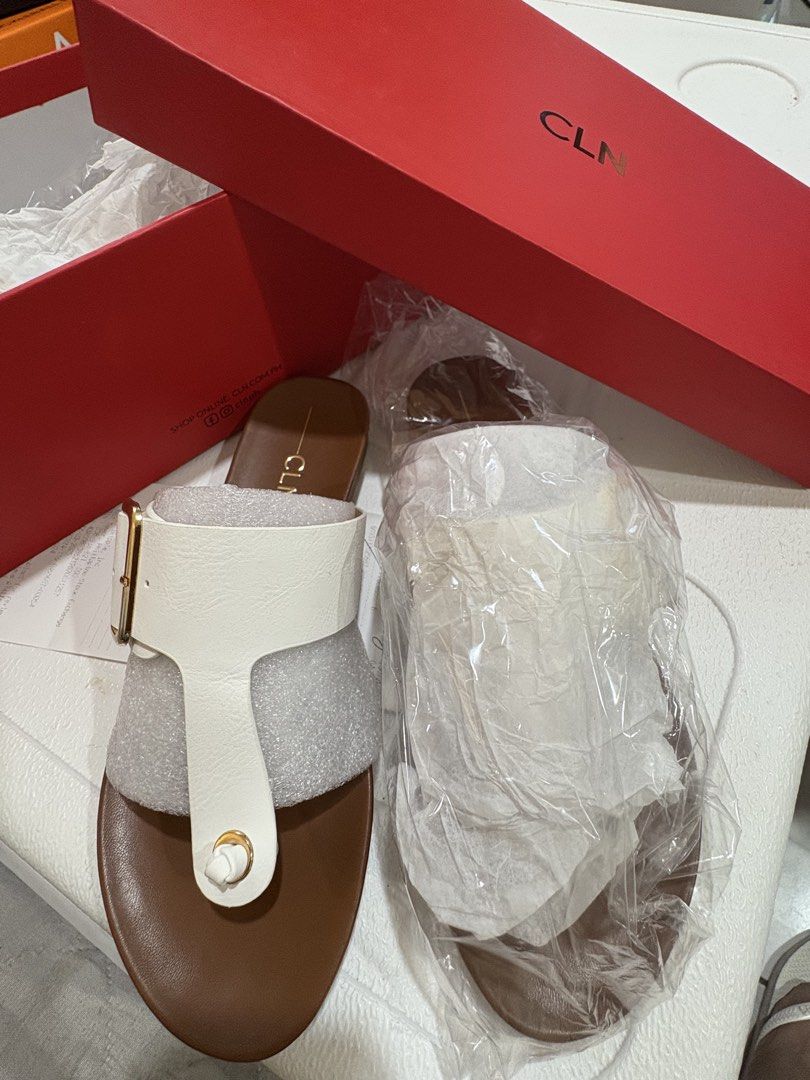 CLN Adana White Sandals Size 35 (Category: Flats & Sandals) located in Quezon City. Submitted by staytunedcloset (Listing ID 1465821668, Image 3). Description: - Brand: CLN - Model: Adana Slides - Color: White with gold buckle and brown footbed - Size: 35 - Condition: Brand new, never worn - Inclusion: Original red box and online receipt - Style: Toe post design, perfect for casual days Accepts GCash, BDO payments only. .