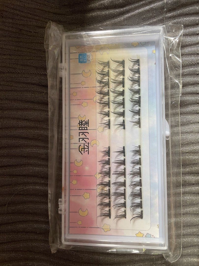 Cluster false eyelashes set in storage case (Category: Makeup) located in Manila. Submitted by tabayjane158126 (Listing ID 1465775289, Image 1). Description: - Brand new, unused cluster false eyelashes set - Includes multiple rows of individual lashes for custom looks - Comes in a convenient clear storage case with vibrant backing paper - Sealed in a plastic wrapper for hygiene and safety - Perfect for easy DIY lash extensions at home - On-hand a