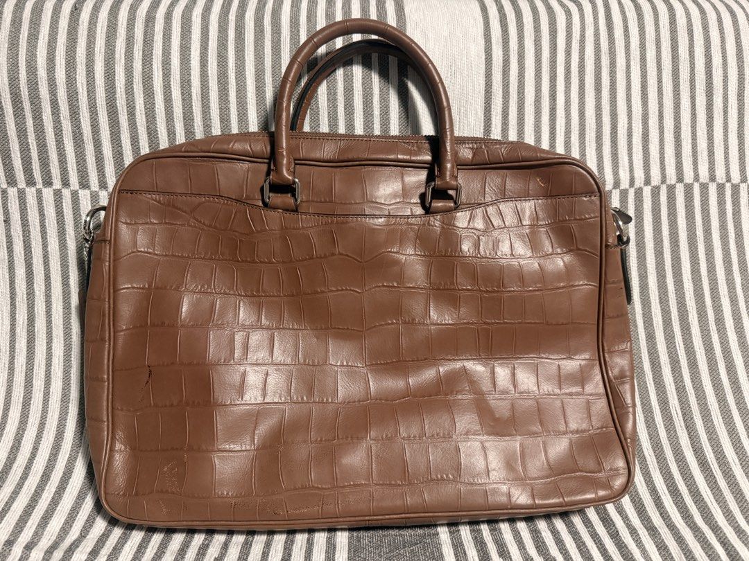 Coach Brown Crocodile Embossed Leather Briefcase Laptop Bag (Category: Luxury Bags & Wallets) located in Caloocan City. Submitted by kimterest (Listing ID 1465873335, Image 3). Description: - Brand/Model: Coach briefcase in brown crocodile embossed leather - Hardware: Dark gunmetal with Coach New York debossed logo - Strap: Includes detachable black and brown shoulder strap with swivel lobster clasps and matching leather hangtag - Condition: Clea