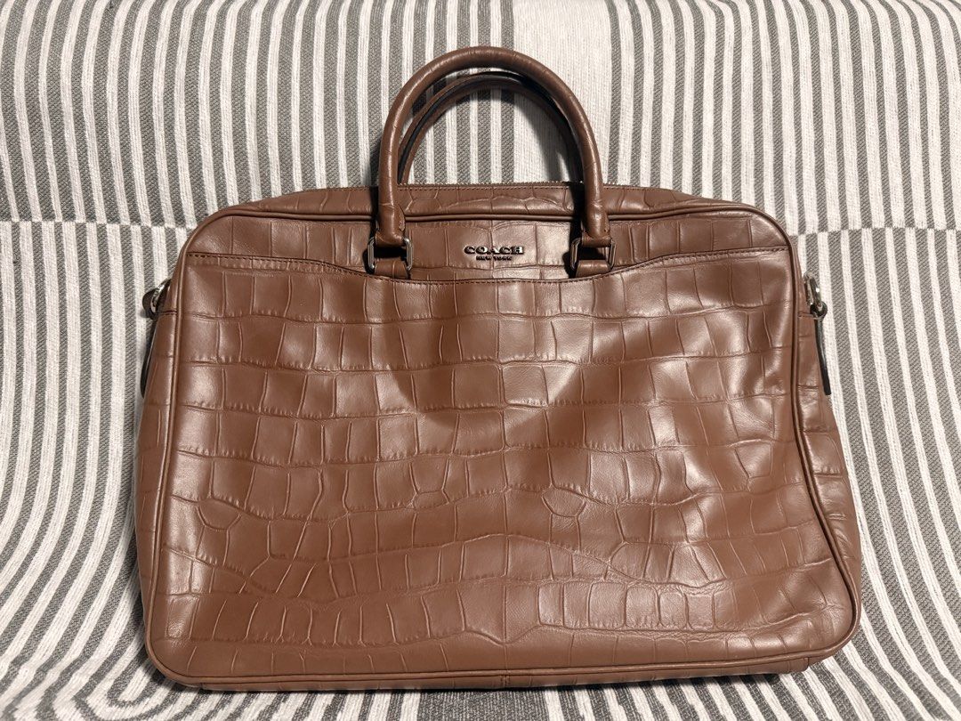 Coach Brown Crocodile Embossed Leather Briefcase Laptop Bag (Category: Luxury Bags & Wallets) located in Caloocan City. Submitted by kimterest (Listing ID 1465873335, Image 2). Description: - Brand/Model: Coach briefcase in brown crocodile embossed leather - Hardware: Dark gunmetal with Coach New York debossed logo - Strap: Includes detachable black and brown shoulder strap with swivel lobster clasps and matching leather hangtag - Condition: Clea