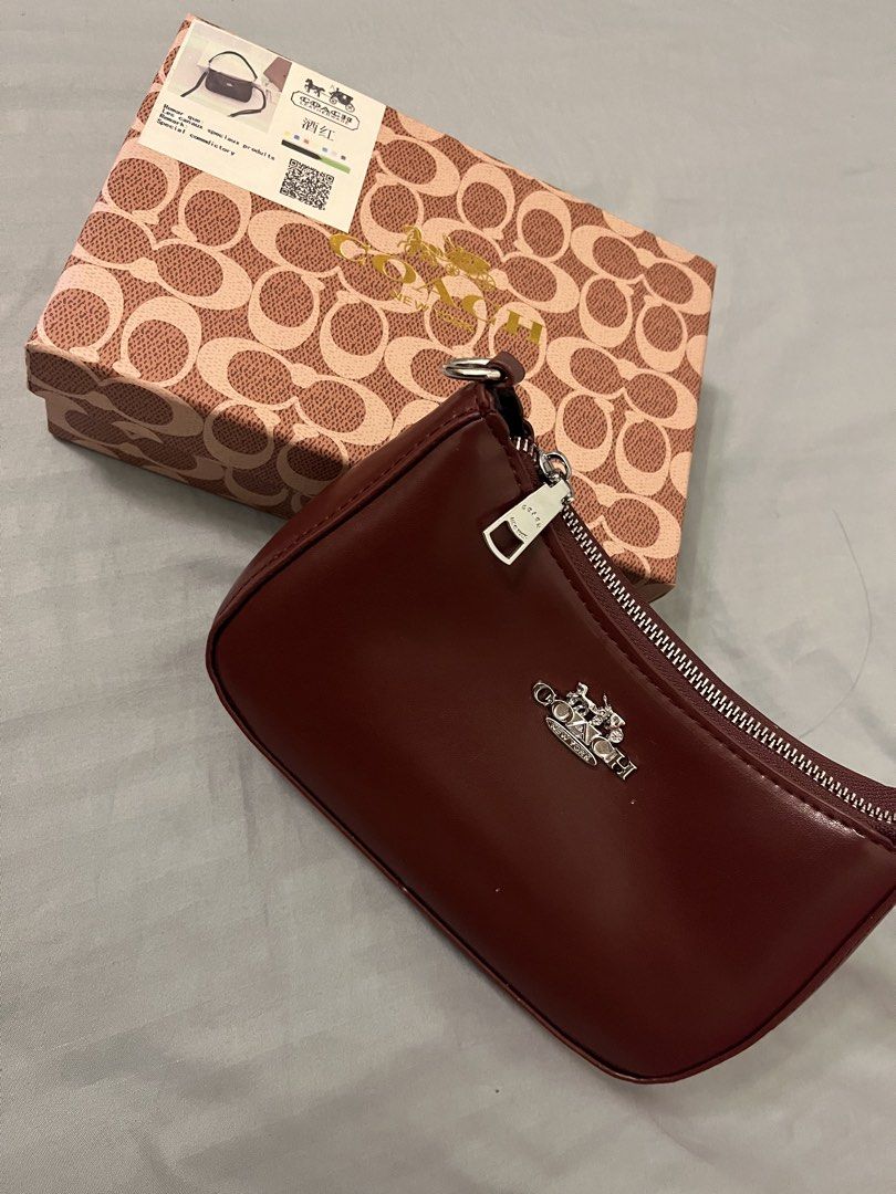 Coach Burgundy Leather Shoulder Bag with Box (Category: Shoulder Bags) located in Caloocan City. Submitted by dubaichewycooki (Listing ID 1465761298, Image 1). Description: - Brand: Coach - Color: Burgundy leather with silver hardware - Features: Secure zipper closure and metal front logo - Inclusions: Matching signature patterned box with tag details and straps - Condition: Brand new, never used, pristine condition.
