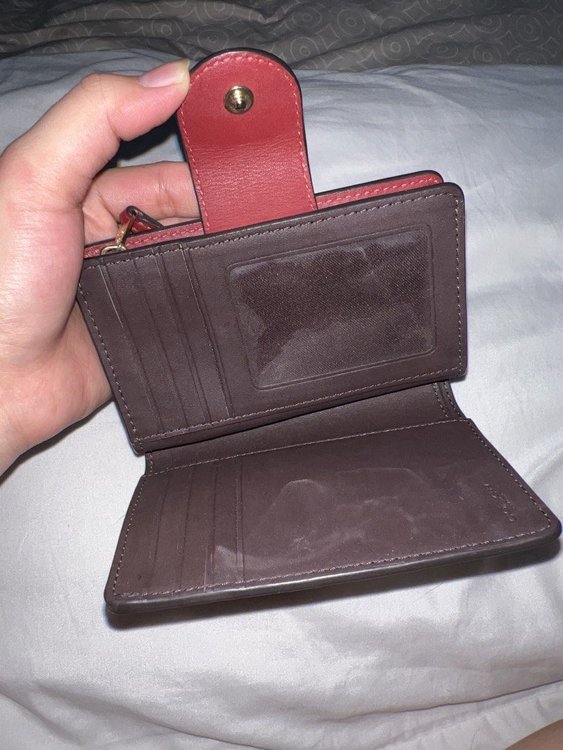 Coach Cherry Signature Leather Medium Corner Zip Wallet (Category: Wallets & Card holders) located in Marikina City. Submitted by ash_2 (Listing ID 1465880019, Image 2). Description: Coach wallet in IM/Cherry colorway. Signature debossed leather exterior with snap closure and gold-tone hardware. Interior contains multiple card slots, ID window, bill compartment, and a zip coin pocket. Complete with original tag showing $222.99 USD / $228.00 CAD a