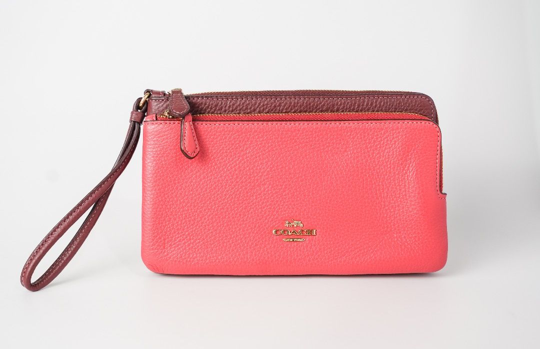 Coach Double Zip Wristlet Wallet Pink Maroon (Category: Wallets & Card holders) located in Pasig City. Submitted by laagn.ph (Listing ID 1465764474, Image 3). Description: - Authentic Coach double zip wristlet - Stylish two-tone bright pink and deep maroon pebbled leather - Elegant gold hardware with gold foil Coach logo - Dual zippered compartments with an extra middle slip pocket - Includes a matching attached wrist strap.