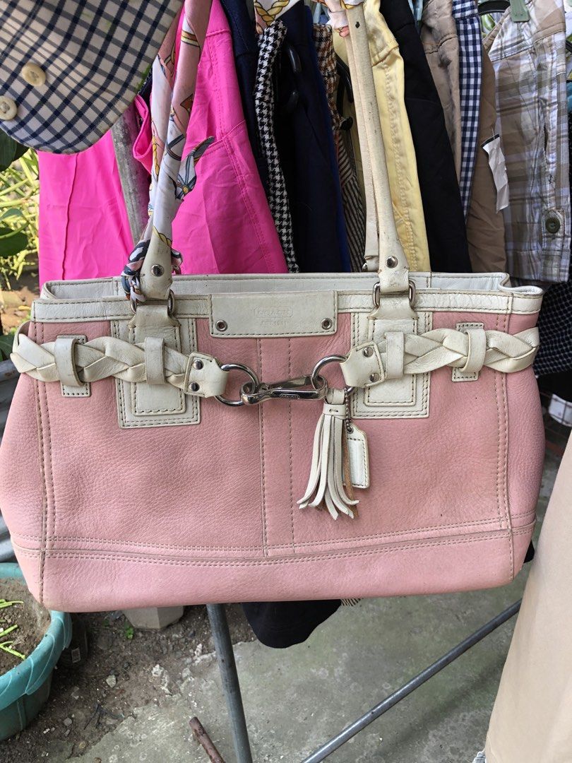 Coach Leather Handbag Pink and White (Category: Luxury Bags & Wallets) located in Manila. Submitted by tunicy2k (Listing ID 1465760570, Image 1). Description: - Authentic Coach handbag in pink pebbled leather with chic white leather trim - Features a stylish braided front detail, silver-tone hardware, and a matching tassel charm - Dual top handles and secure top zipper closure - Clean beige fabric interior complete with slip pockets and a zip poc