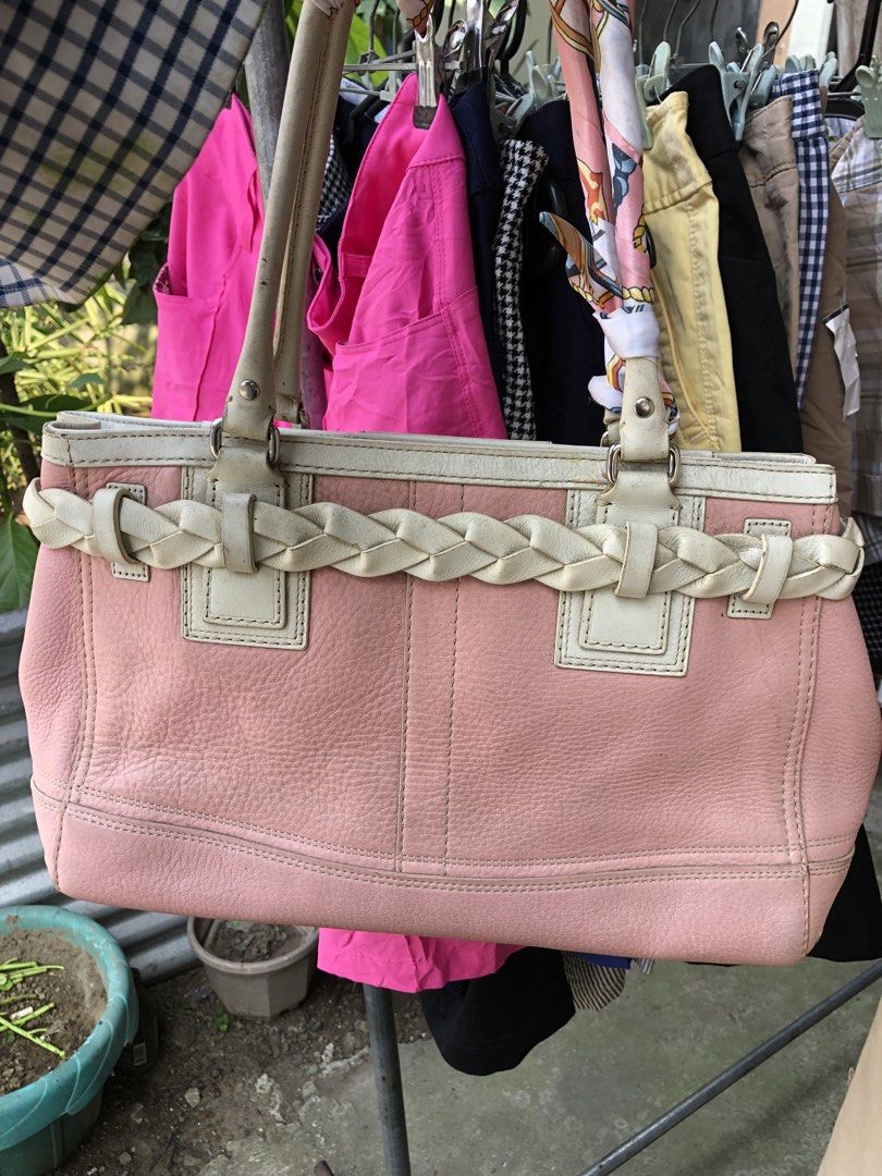 Coach Leather Handbag Pink and White (Category: Luxury Bags & Wallets) located in Manila. Submitted by tunicy2k (Listing ID 1465760570, Image 2). Description: - Authentic Coach handbag in pink pebbled leather with chic white leather trim - Features a stylish braided front detail, silver-tone hardware, and a matching tassel charm - Dual top handles and secure top zipper closure - Clean beige fabric interior complete with slip pockets and a zip poc