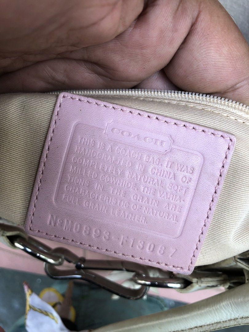 Coach Leather Handbag Pink and White (Category: Luxury Bags & Wallets) located in Manila. Submitted by tunicy2k (Listing ID 1465760570, Image 3). Description: - Authentic Coach handbag in pink pebbled leather with chic white leather trim - Features a stylish braided front detail, silver-tone hardware, and a matching tassel charm - Dual top handles and secure top zipper closure - Clean beige fabric interior complete with slip pockets and a zip poc