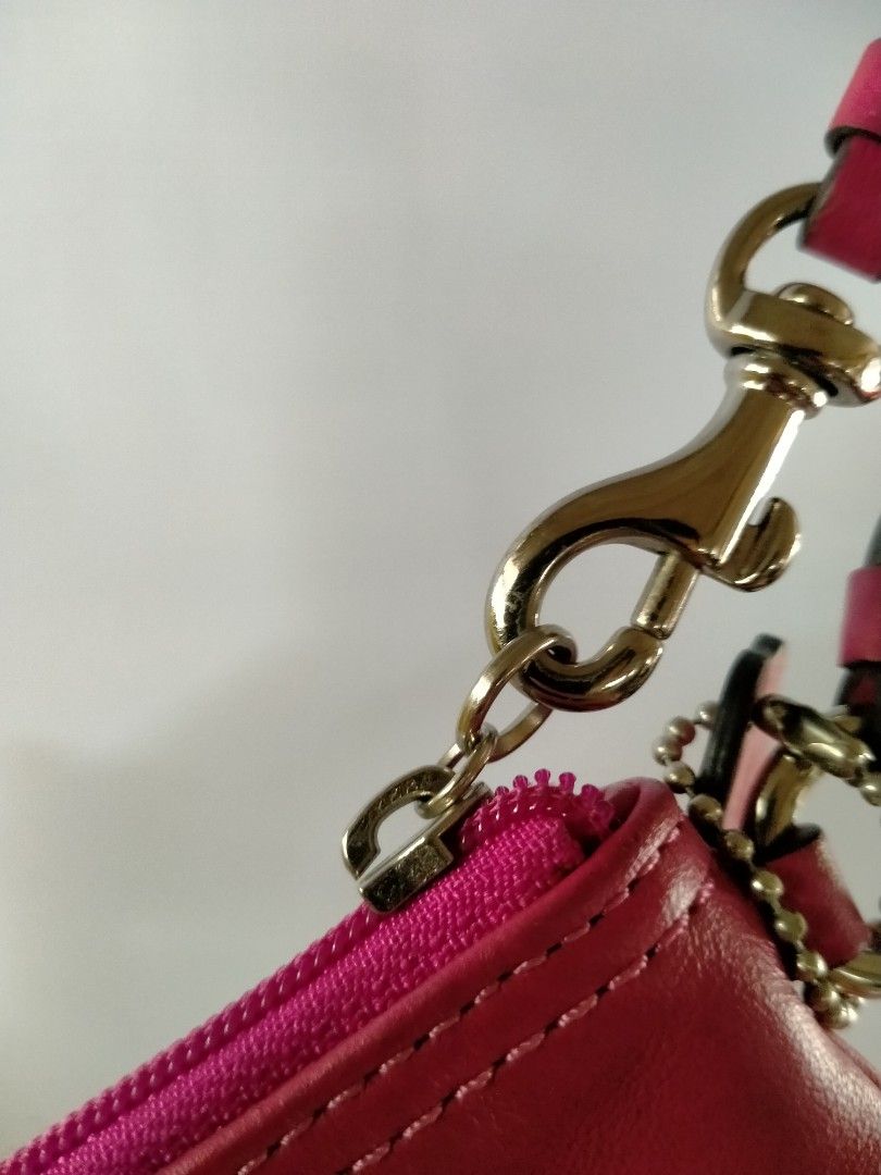 Coach Pink Leather Wristlet (Category: Luxury Bags & Wallets) located in Davao. Submitted by ervinpolino09 (Listing ID 1465787279, Image 3). Description: - Authentic Coach New York wristlet in a vibrant bright pink smooth leather - Silver-tone hardware with a secure top zip closure - Includes a matching detachable wrist strap and chic embossed hangtag - Fabric-lined interior equipped with 2 open slip pockets for easy organization - Compact and ve