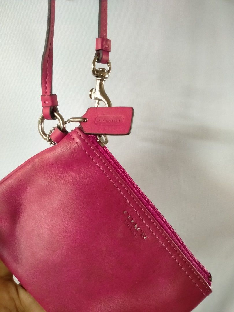 Coach Pink Leather Wristlet (Category: Luxury Bags & Wallets) located in Davao. Submitted by ervinpolino09 (Listing ID 1465787279, Image 2). Description: - Authentic Coach New York wristlet in a vibrant bright pink smooth leather - Silver-tone hardware with a secure top zip closure - Includes a matching detachable wrist strap and chic embossed hangtag - Fabric-lined interior equipped with 2 open slip pockets for easy organization - Compact and ve