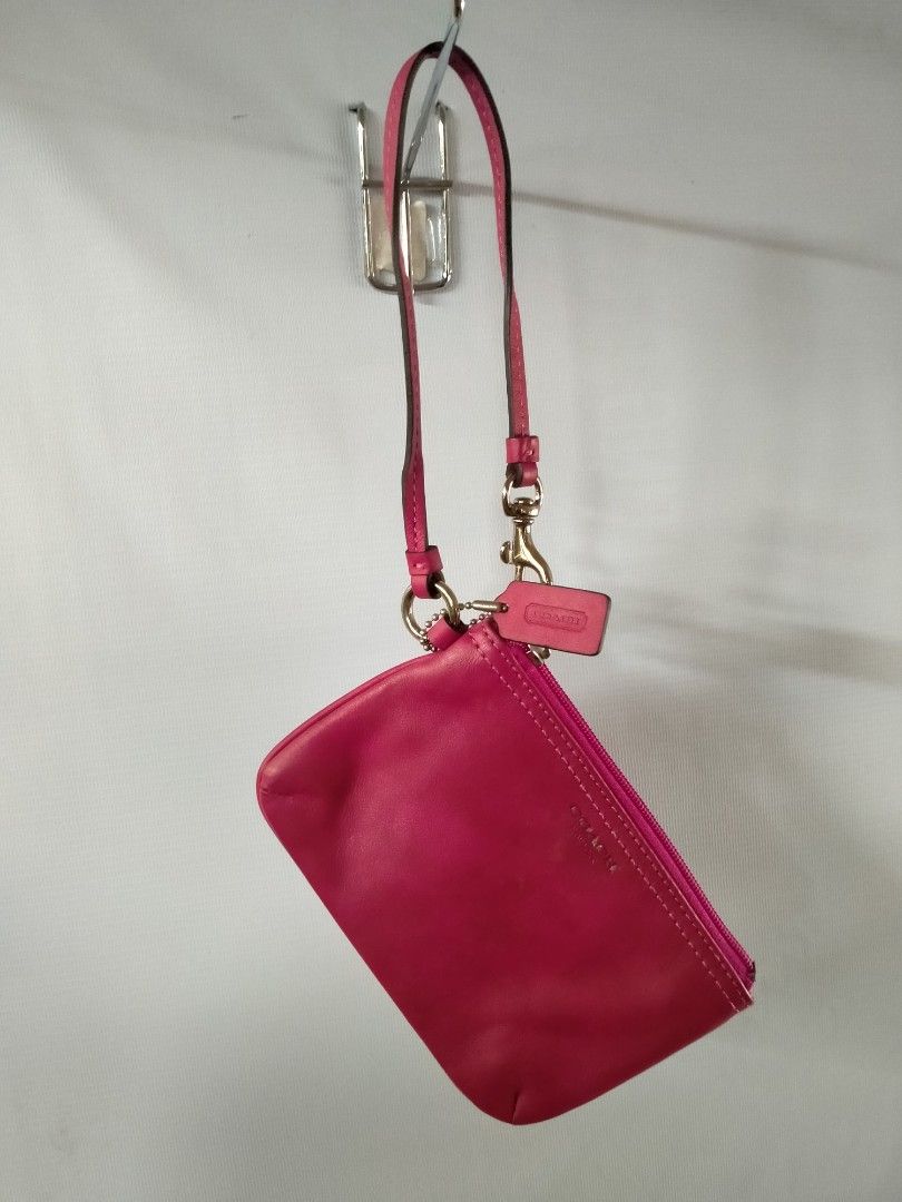 Coach Pink Leather Wristlet (Category: Luxury Bags & Wallets) located in Davao. Submitted by ervinpolino09 (Listing ID 1465787279, Image 1). Description: - Authentic Coach New York wristlet in a vibrant bright pink smooth leather - Silver-tone hardware with a secure top zip closure - Includes a matching detachable wrist strap and chic embossed hangtag - Fabric-lined interior equipped with 2 open slip pockets for easy organization - Compact and ve