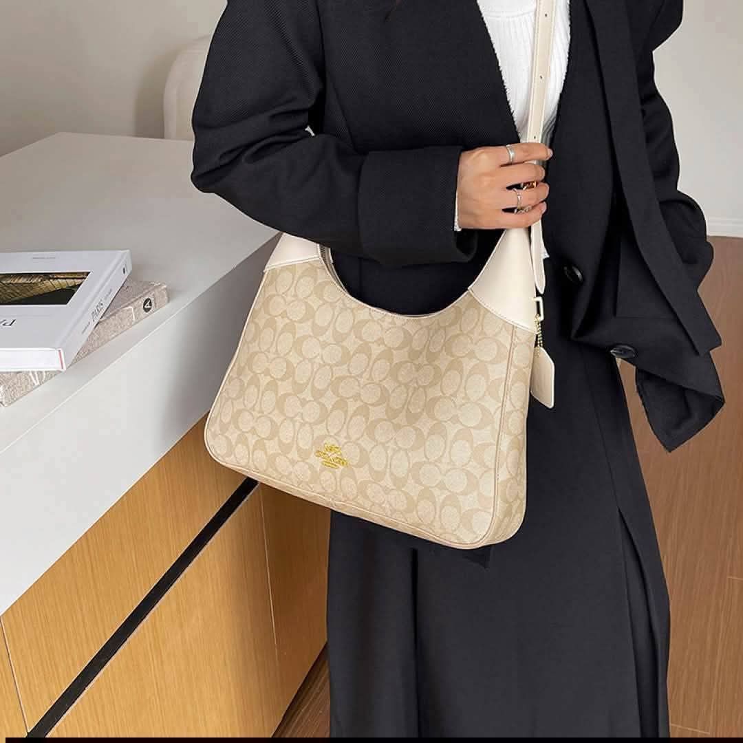 Coach Signature C Pattern Hobo Shoulder Bag (Category: Luxury Bags & Wallets) located in Manila. Submitted by jaemalda (Listing ID 1465864565, Image 1). Description: - Authentic Coach hobo shoulder bag with signature C monogram - Durable coated canvas with smooth leather trim and gold-tone hardware - Adjustable shoulder strap for a comfortable fit - Secure zip-top closure with iconic hanging leather tag - Spacious fabric-lined interior equipped w