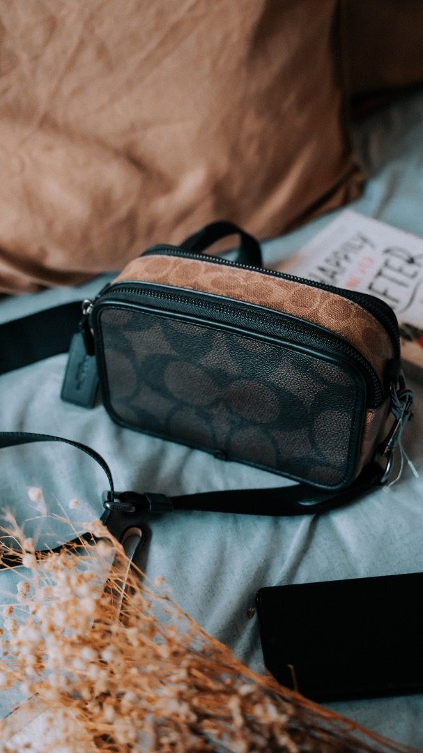 Coach sling bag (Category: Sling Bags) located in Pasig City. Submitted by laagn.ph (Listing ID 1465765726, Image 1). Description: - Authentic-style Coach sling bag - Brown signature monogram pattern with black leather accents - Compact camera bag design with double zip closure - Durable adjustable black strap for comfortable wear - Includes signature embossed Coach leather hangtag - Ideal for casual outings and everyday use.