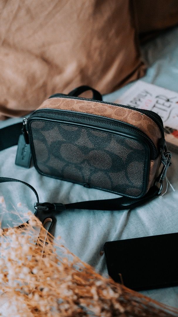 Coach sling bag (Category: Sling Bags) located in Pasig City. Submitted by laagn.ph (Listing ID 1465765726, Image 2). Description: - Authentic-style Coach sling bag - Brown signature monogram pattern with black leather accents - Compact camera bag design with double zip closure - Durable adjustable black strap for comfortable wear - Includes signature embossed Coach leather hangtag - Ideal for casual outings and everyday use.
