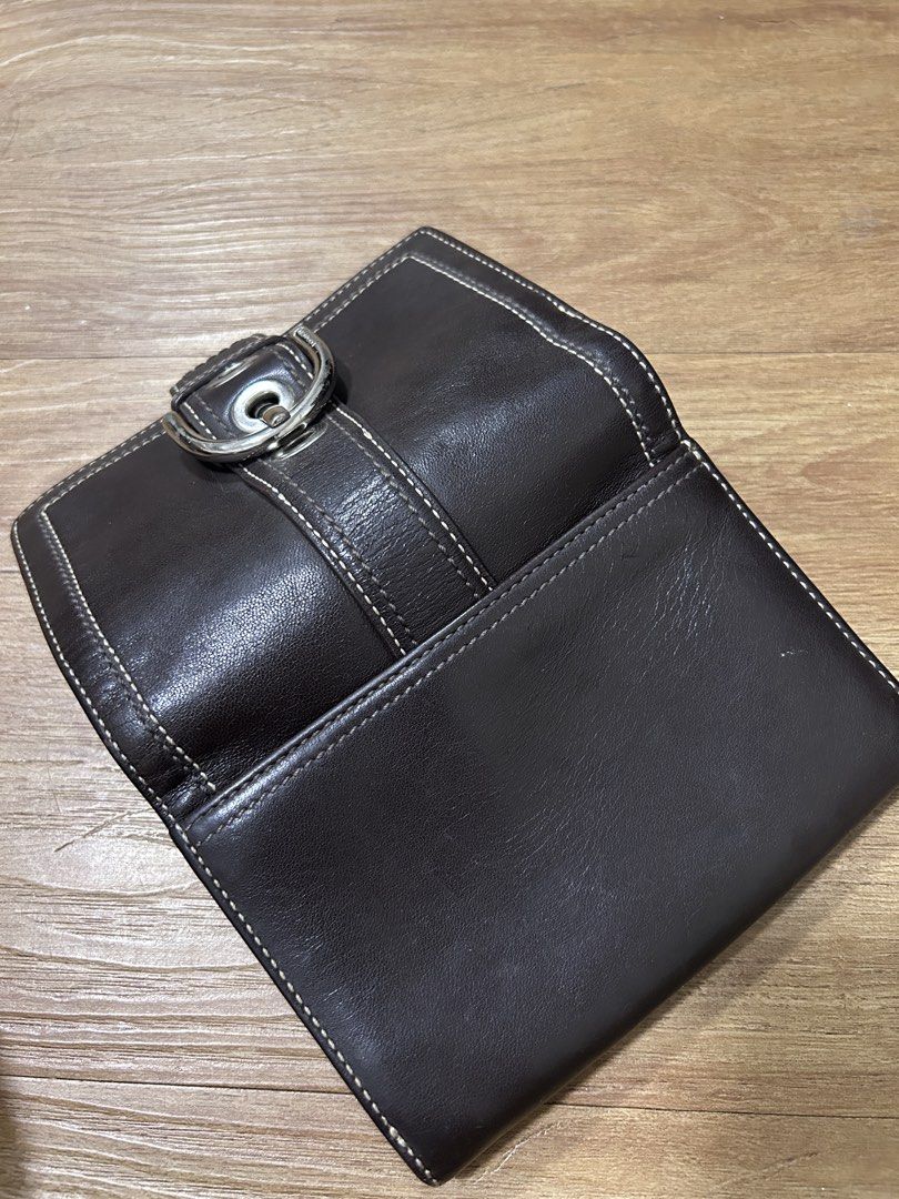 Coach Soho Leather Buckle Wallet (Category: Wallets & Card holders) located in Del Monte. Submitted by antonja (Listing ID 1465864123, Image 3). Description: - Brand: Coach - Material: Dark brown leather with contrast stitching - Hardware: Silver-tone buckle closure - Compartments: Multiple card slots and cash compartments - Pockets: Convenient zippered coin pocket inside and slip pocket on the back - Size: Compact, fits easily in hand or small b