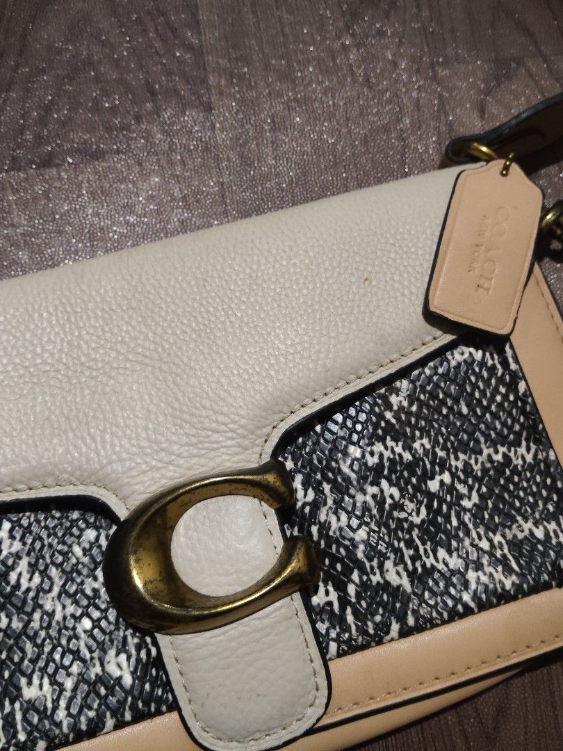Coach Tabby Shoulder Bag Snake Print Tan White (Category: Luxury Bags & Wallets) located in Mamburao. Submitted by renzocutie (Listing ID 1465932602, Image 2). Description: off/legit -Coach shoulder bag in tan leather and black-and-white snake print texture - Eye-catching brass 'C' hardware on the front flap closure - Adjustable long strap with metal clasps for versatile wear - Comes with the original matching Coach leather hangtag - Luxurious mu