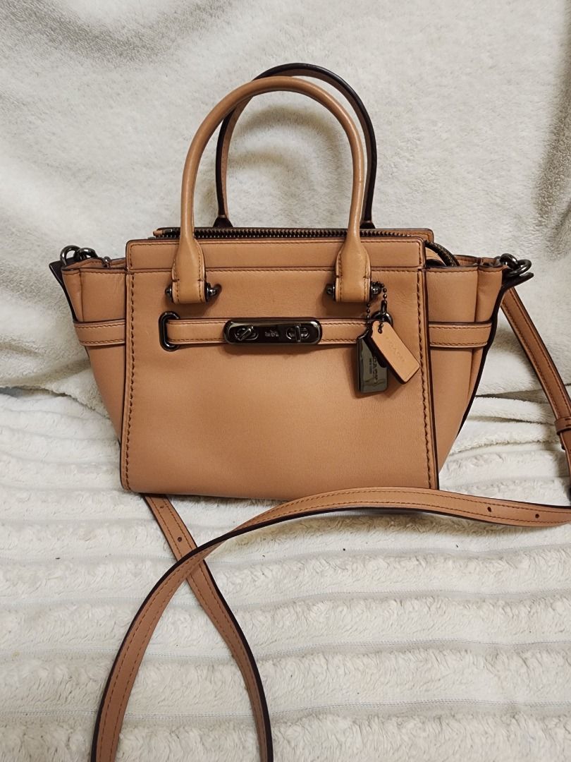 Coach Tan Leather Handbag with Strap (Category: Luxury Bags & Wallets) located in Caloocan City. Submitted by keenmoon.752ef0 (Listing ID 1465889757, Image 1). Description: - Brand: Coach - Material: Premium tan leather - Hardware: Sleek gunmetal - Straps: Dual top handles + matching removable shoulder strap - Closure: Secure zip top - Base: Protective metal feet - Interior: Clean, spacious compartments - Condition: Excellent / Well-maintained - 
