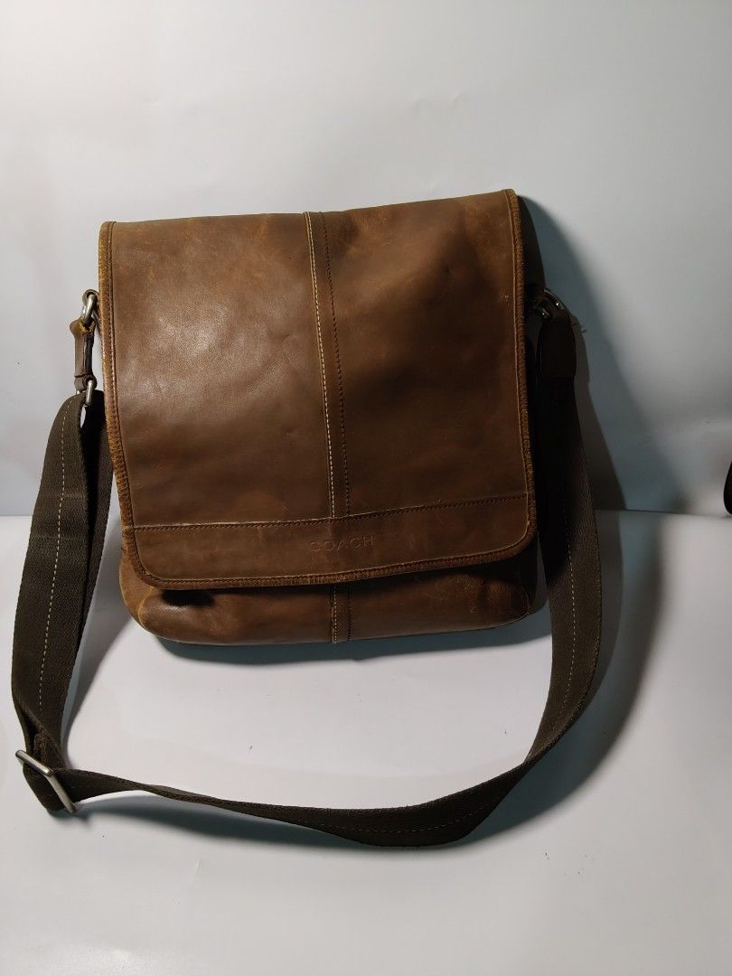 Coach VINTAGE MESSENGER BAG (Category: Sling Bags) located in Valencia. Submitted by coolwolf_27a64f (Listing ID 1465885311, Image 1). Description: vintage brown leather Coach messenger bag, distinguished by its front flap featuring a debossed logo and distinct vertical center seam detailing. Dimension 15x13 FLAWS, SCRATCHES LEATHER DISCOLORATION.