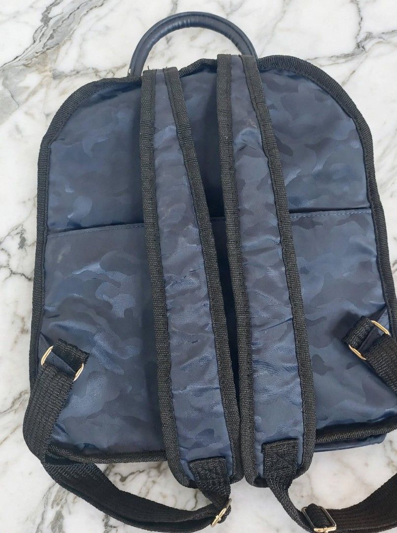 Coeur Deux Moda Italy Blue Camo Backpack (Category: Backpacks) located in Caloocan City. Submitted by chonadura91470 (Listing ID 1465777029, Image 2). Description: - Brand: Coeur Deux Moda Italy - Design: Navy blue camouflage pattern with metal hardware and front branded badge - Storage: Zippered main compartment and front pocket - Comfort: Adjustable shoulder straps and convenient top grab handle - Interior: Brown silky fabric lining - Condition