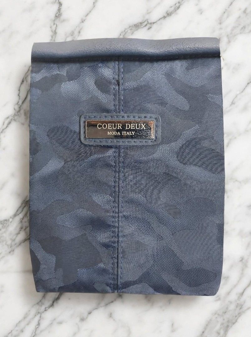 Coeur Deux Moda Italy Blue Camo Backpack (Category: Backpacks) located in Caloocan City. Submitted by chonadura91470 (Listing ID 1465777029, Image 3). Description: - Brand: Coeur Deux Moda Italy - Design: Navy blue camouflage pattern with metal hardware and front branded badge - Storage: Zippered main compartment and front pocket - Comfort: Adjustable shoulder straps and convenient top grab handle - Interior: Brown silky fabric lining - Condition
