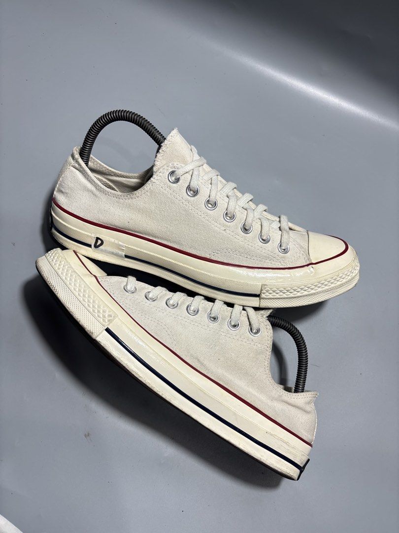 Converse Chuck 70 Low White Parchment Size 9-9.5 (Category: Sneakers) located in Butuan. Submitted by shoeetasho (Listing ID 1465927902, Image 3). Description: - Brand: Converse Chuck 70 Low Top - Color: Parchment White - Size: US 9-9.5 / EUR 42.5 / 27.5cm - Condition: Minimal wear on soles and uppers, clean laces included - Features: Classic rubber toe cap, vulcanized rubber sole with black/red foxing stripes, and black heel license plates.