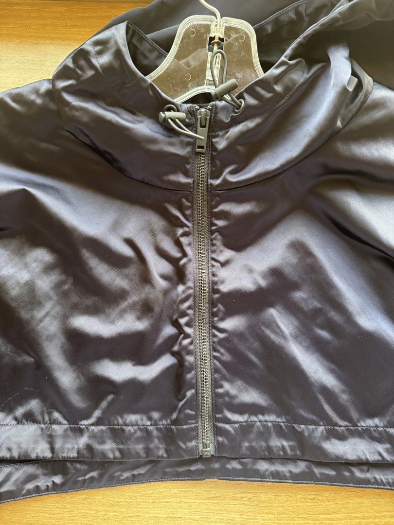COS Cropped Hooded Jacket Dark Navy Blue (Category: Coats, Jackets and Outerwear) located in Manila. Submitted by prinsloo_ (Listing ID 1465817605, Image 2). Description: - Brand: COS - Style: Cropped windbreaker - Color: Dark navy blue - Size: M/L - Features: Zip front, adjustable hood drawstrings, high collar, and zippered cuffs - Fabric: Shiny technical finish - Condition: Clean inside and out, great lightweight layer Measurements: Shoulders -