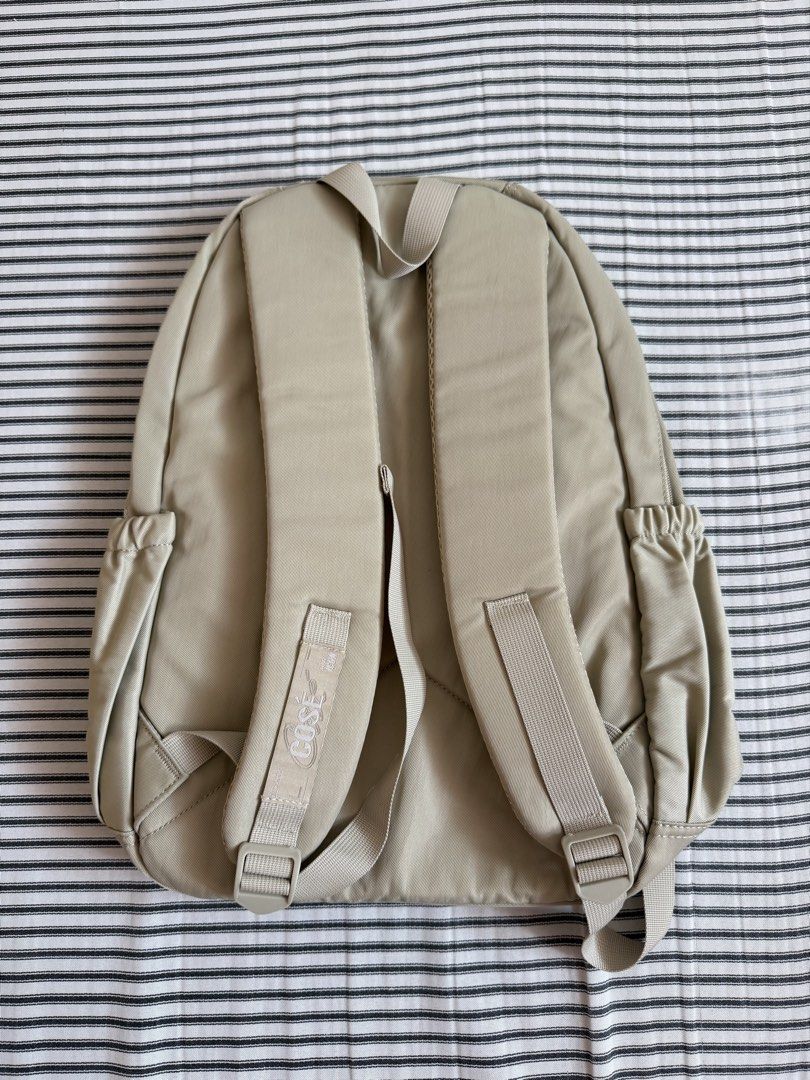 Cose Beige Casual Backpack with Multiple Compartments (Category: Backpacks) located in Cavite. Submitted by chinitolover (Listing ID 1465769921, Image 3). Description: - NEVER BEEN USED - Material: Sturdy canvas - Compartments: Main zip compartment and front zipped pocket - Pouch: Two side water bottle pouches - Comfort: Padded shoulder straps with adjustable buckles - Best for: Everyday campus use or travel.